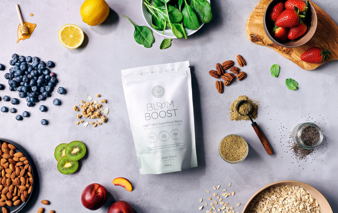 Low-FODMAP fiber ingredients including flax, chia, hemp hearts, oat bran, pumpkin seeds, and psyllium husk in ceramic bowls on a neutral background