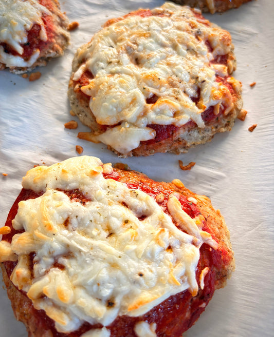 No-yeast mini pizzas made with Bloom Boost, topped with tomato sauce and melted mozzarella cheese