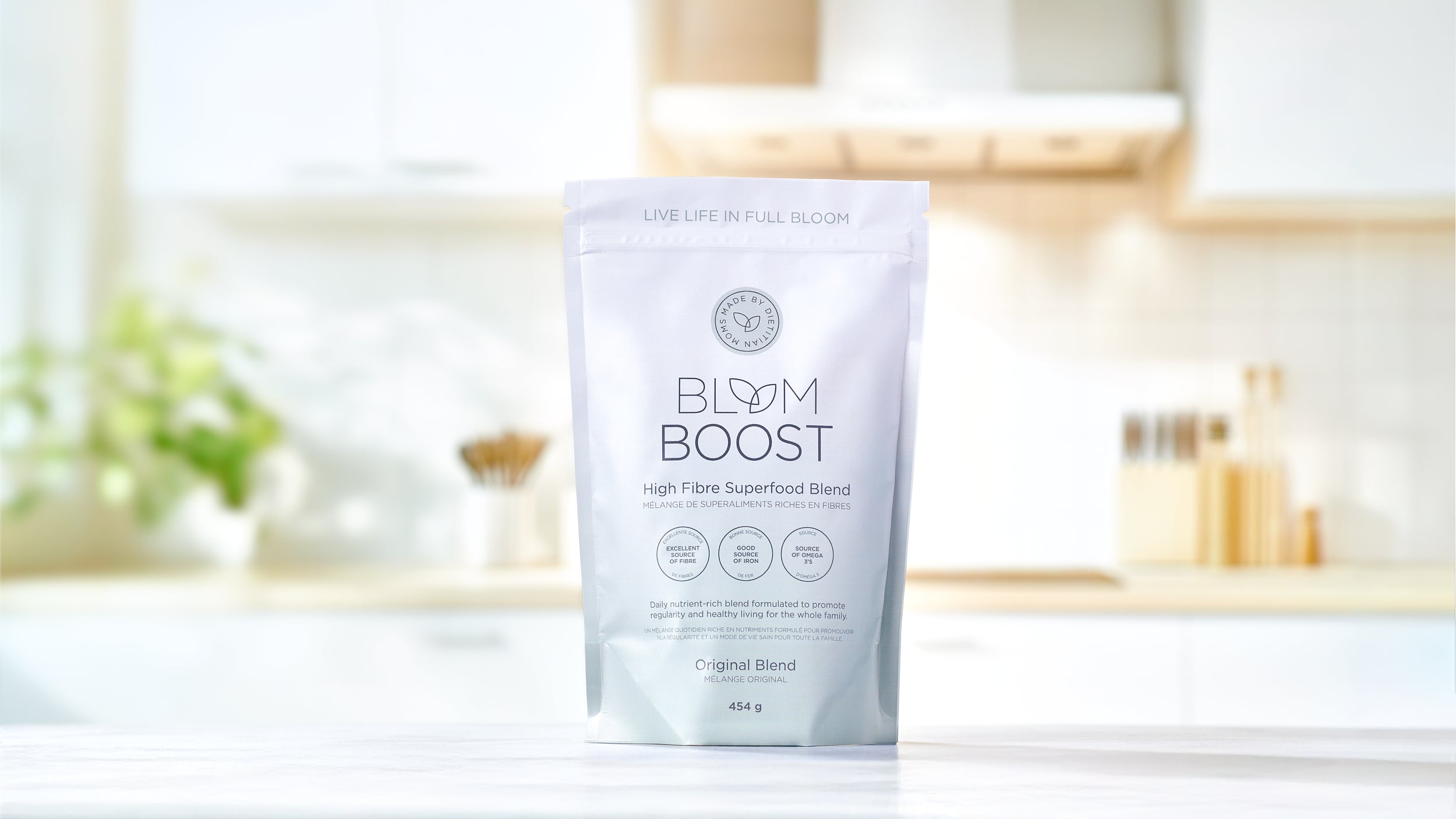 Bloom Boost stand-up pouch on a bright kitchen counter -- fiber, iron, protein, and omega-3s with no added additives, preservatives, or colors.